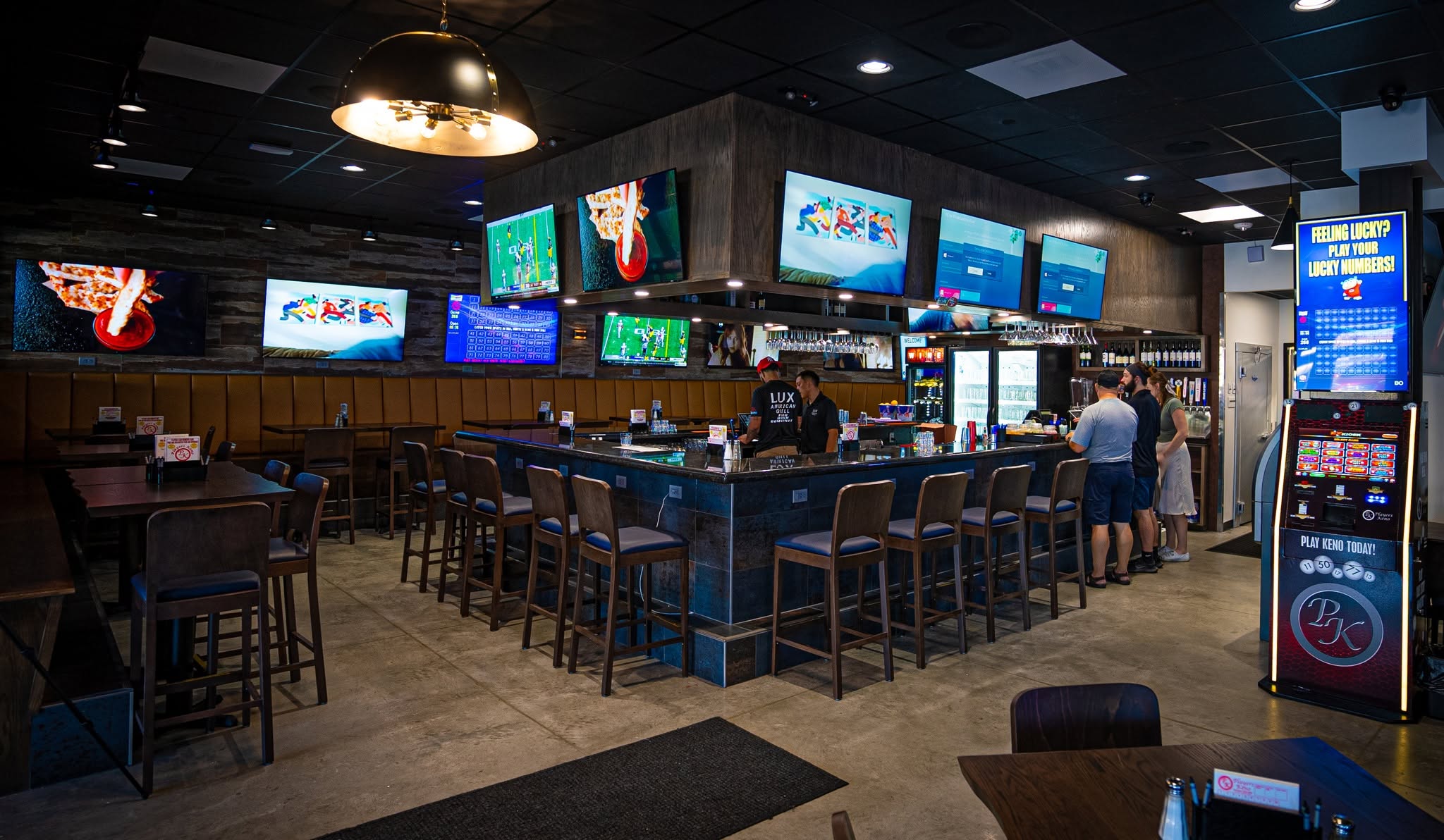 Friends celebrating with food and drinks at Lux American Grill in Papillion